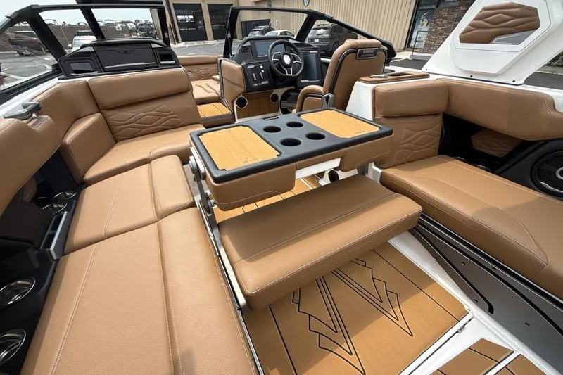 Slide: The Image of Luxurious interior of 2025 Supra SA 550 boat with tan leather seating and modern dashboard. - 23