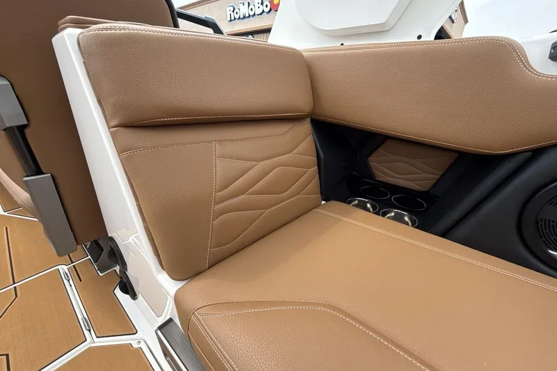 Slide: The Image of 2025 Supra SA 550 boat interior with tan leather seating and cup holders. - 24
