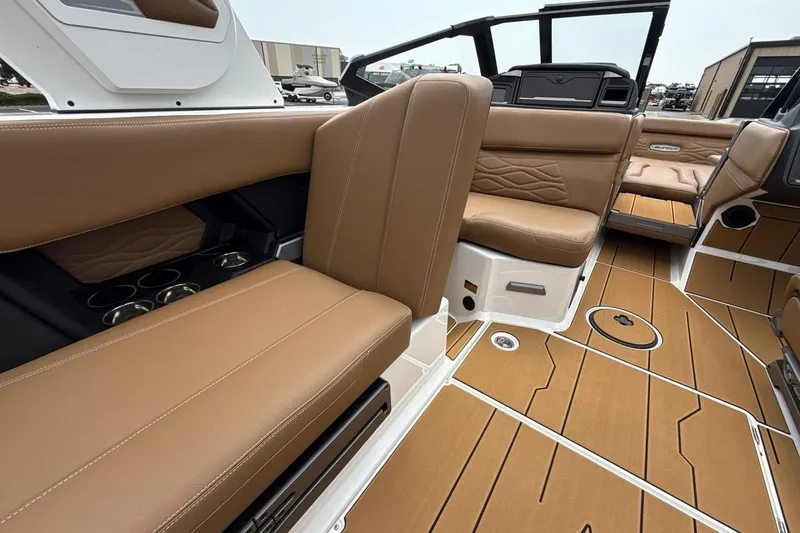 Slide: The Image of 2025 Supra SA 550 boat interior with tan leather seats and modern design. - 25
