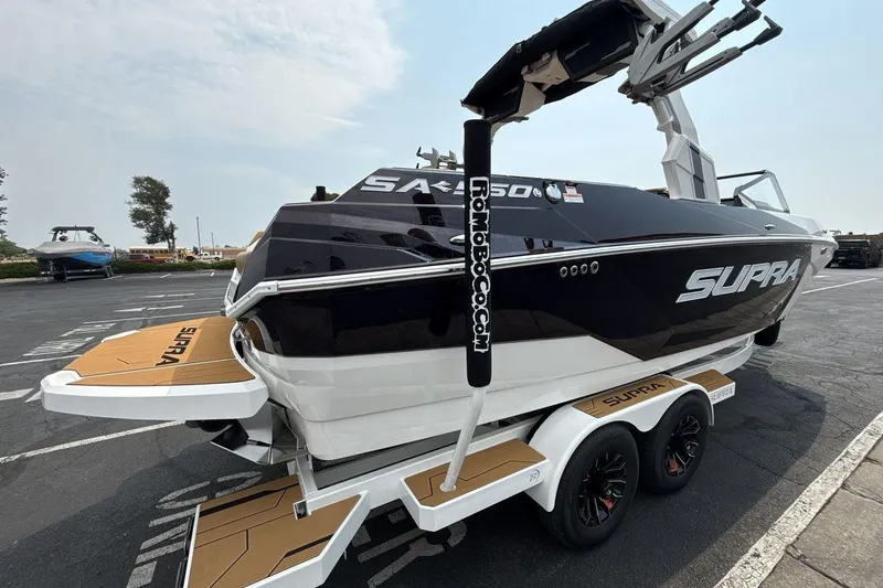 Slide: The Image of 2025 Supra SA 550 boat on trailer, sleek design, black and white color scheme. - 5
