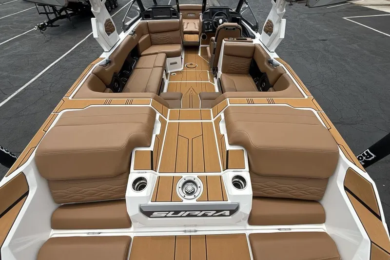 Slide: The Image of Luxurious interior of 2025 Supra SA 550 boat with tan seating and sleek design. - 9