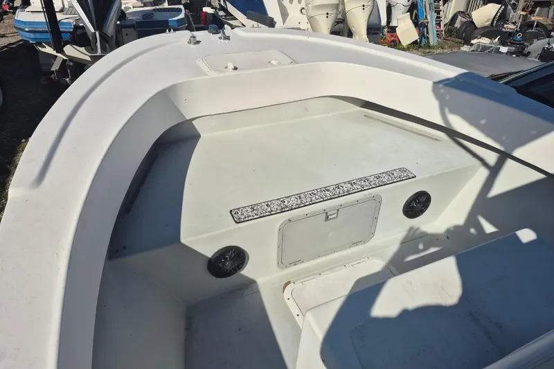 Slide: The Image of 1993 Dusky 227 Open Fisherman boat interior with storage compartment and speakers. - 10