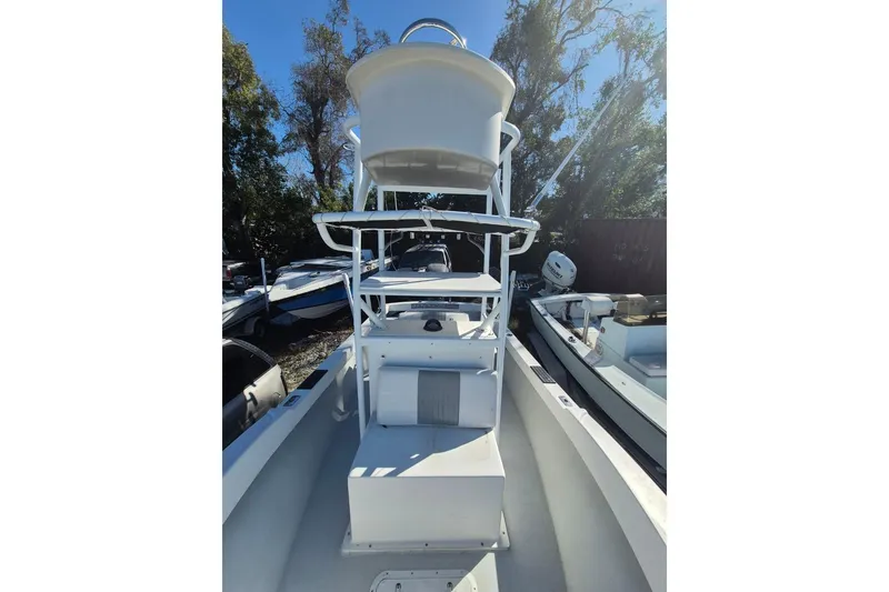 Slide: The Image of 1993 Dusky 227 Open Fisherman boat with elevated helm, docked outdoors. - 12