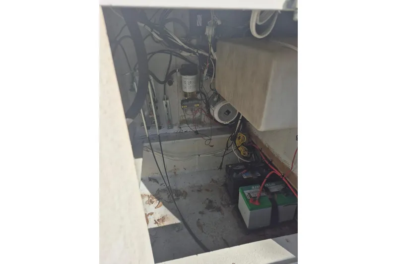 Slide: The Image of Interior view of a 1993 Dusky 227 Open Fisherman boat showing wiring and battery setup. - 13