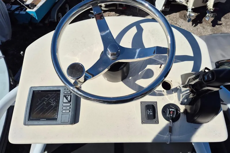 Slide: The Image of 1993 Dusky 227 Open Fisherman boat dashboard with steering wheel and Garmin GPS. - 14