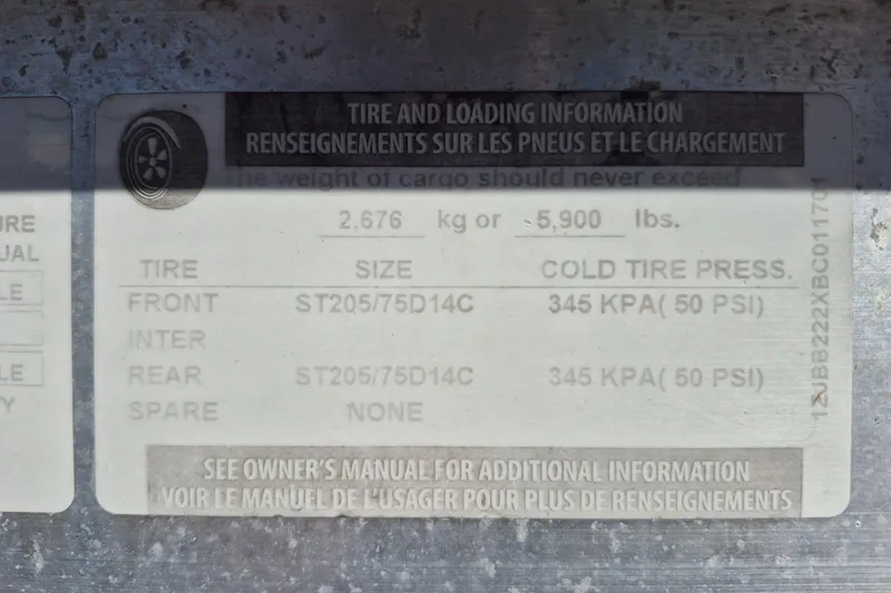 Slide: The Image of Tire and loading information label on a 1993 Dusky 227 Open Fisherman boat. - 19