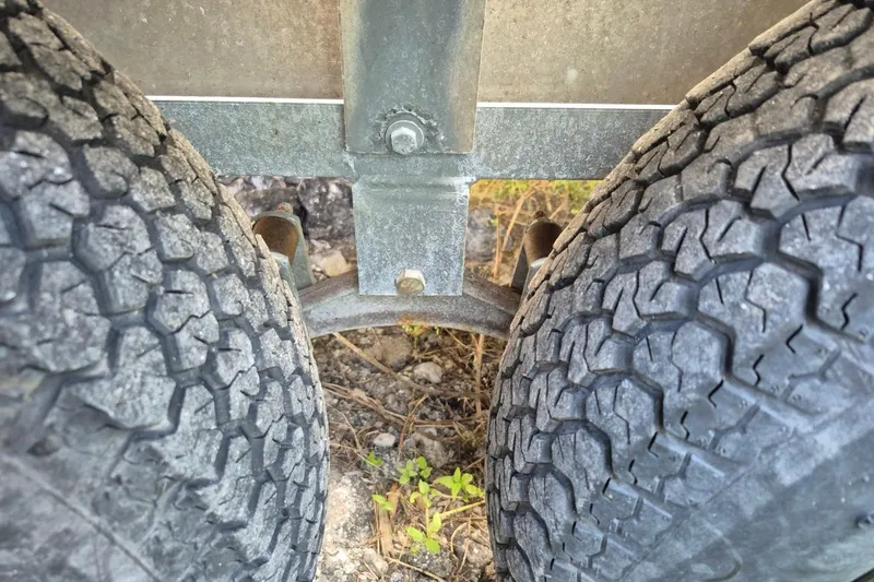 Slide: The Image of Close-up of trailer tires and suspension for 1993 Dusky 227 Open Fisherman boat. - 21