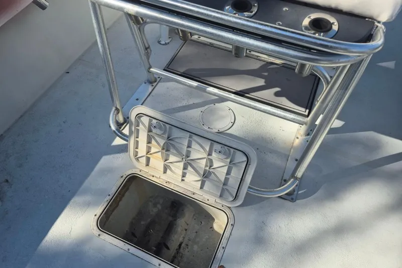 Slide: The Image of 1993 Dusky 227 Open Fisherman boat deck with open storage hatch. - 8