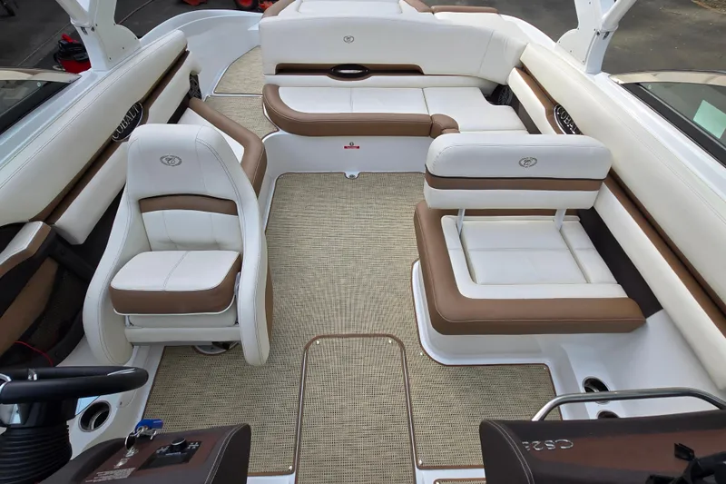 Slide: The Image of 2018 Cobalt CS23 boat interior with white and brown seating, spacious layout. - 16