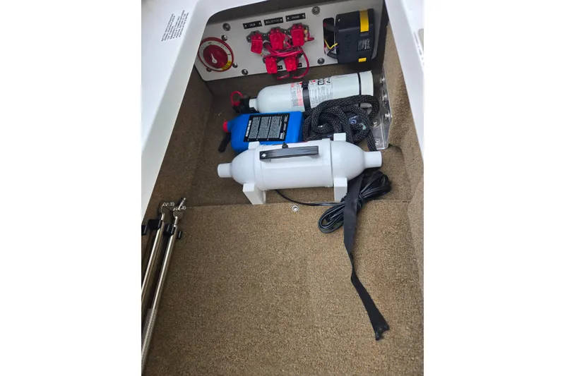 Slide: The Image of Storage compartment of a 2018 Cobalt CS23 boat with safety equipment and accessories. - 18