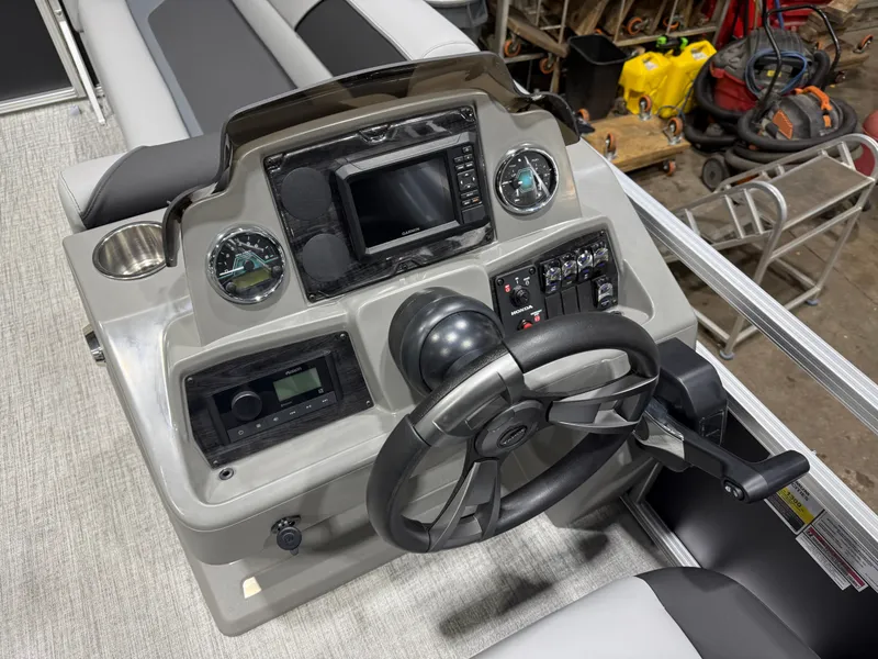 Slide: The Image of 2026 Tahoe Sport boat dashboard with modern electronics. - 12