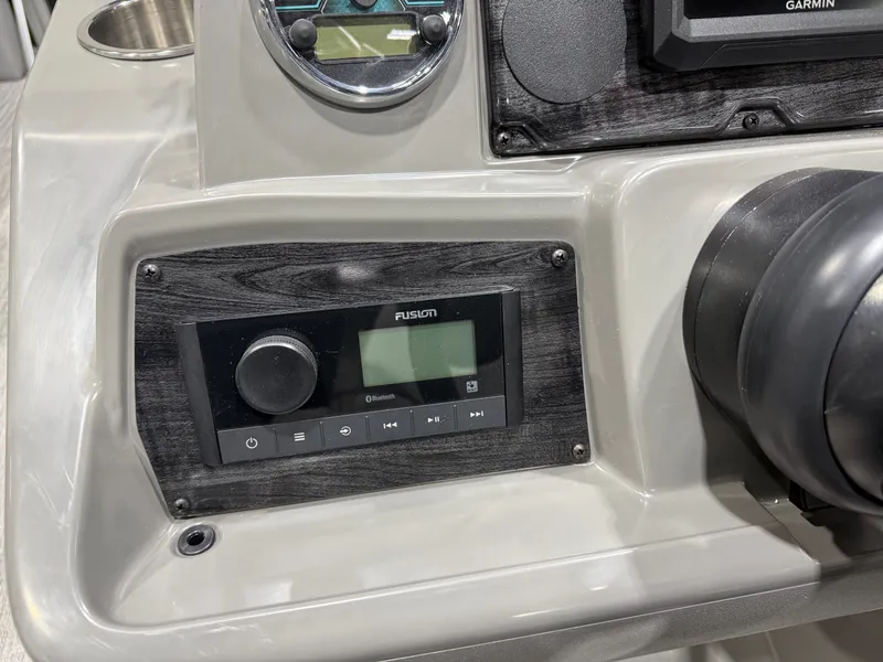 Slide: The Image of 2026 Tahoe Sport boat dashboard with Fusion Bluetooth system. - 14