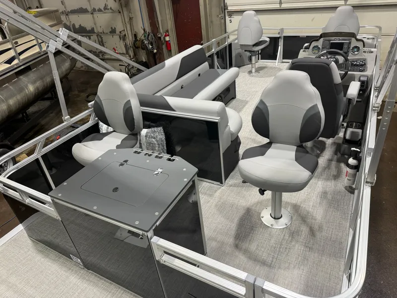 Slide: The Image of 2026 Tahoe Sport Quad Fish Pontoon with gray seating and control console. - 23