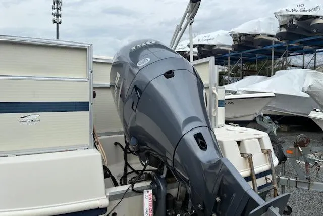 Slide: The Image of 2007 SouthWind 229 Deck Boat with outboard motor in a marina setting. - 10