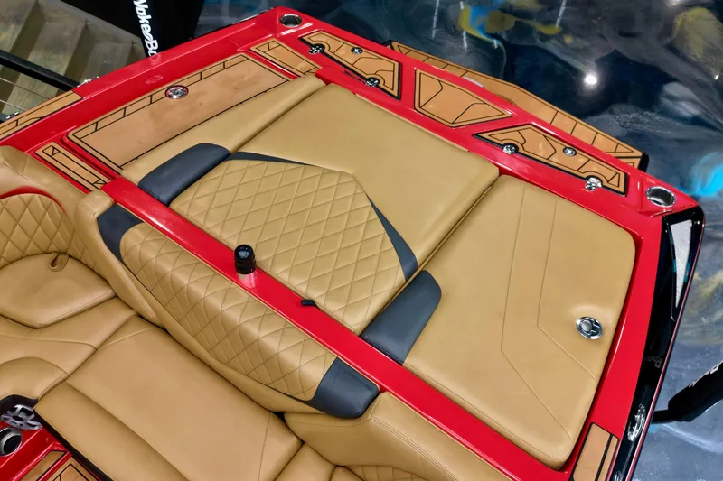 Slide: The Image of 2017 Tigé RZX2 boat interior with tan and red upholstery, featuring diamond stitching. - 13