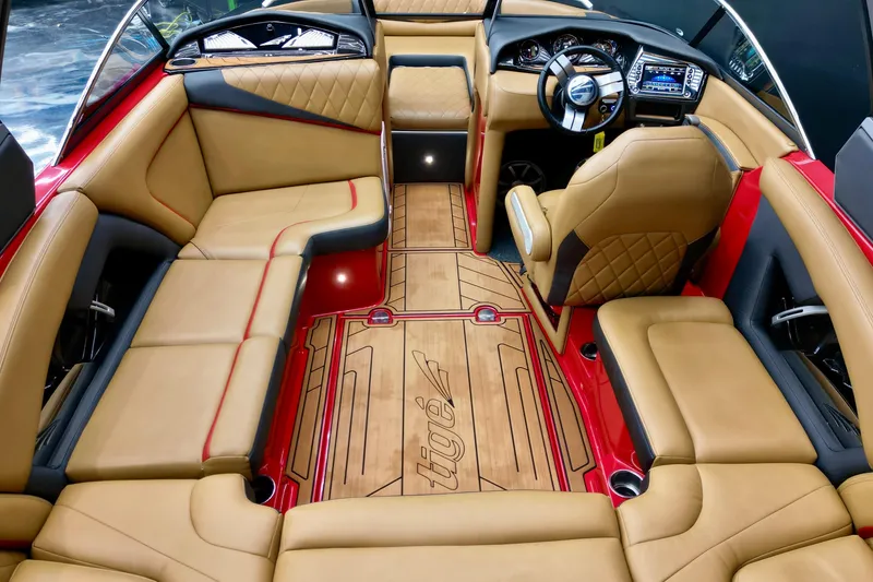Slide: The Image of 2017 Tigé RZX2 boat interior with luxurious tan seating and modern dashboard. - 7