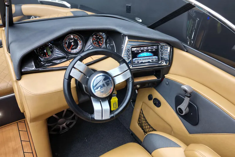 Slide: The Image of 2017 Tigé RZX2 boat dashboard with steering wheel, gauges, and touchscreen display. - 10