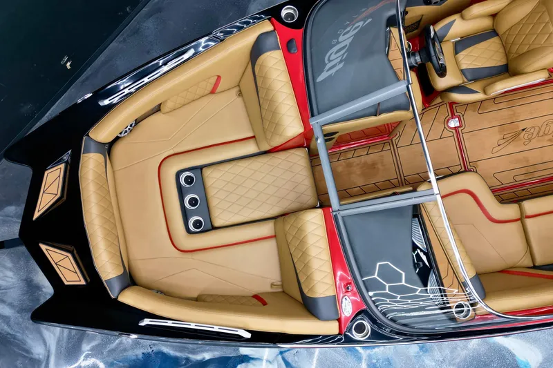 Slide: The Image of 2017 Tigé RZX2 boat interior with tan and red upholstery, featuring sleek design and modern amenities. - 15