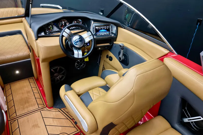 Slide: The Image of 2017 Tigé RZX2 boat interior with tan leather seats and modern dashboard. - 9