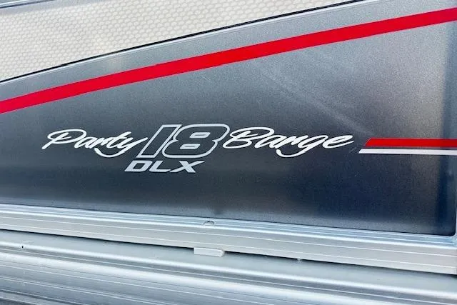 Slide: The Image of 2018 Sun Tracker Party Barge 18 DLX logo with red and silver accents. - 14