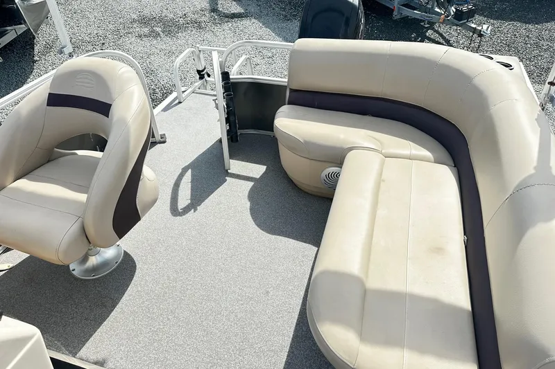 Slide: The Image of 2018 Sun Tracker Party Barge 18 DLX interior with beige seating and carpeted floor. - 16