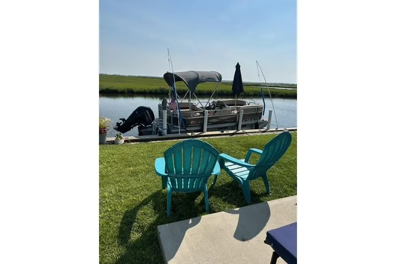 Slide: The Image of 2018 Sun Tracker Bass Buggy 18 Classic pontoon boat with Mercury outboard motor. - 2