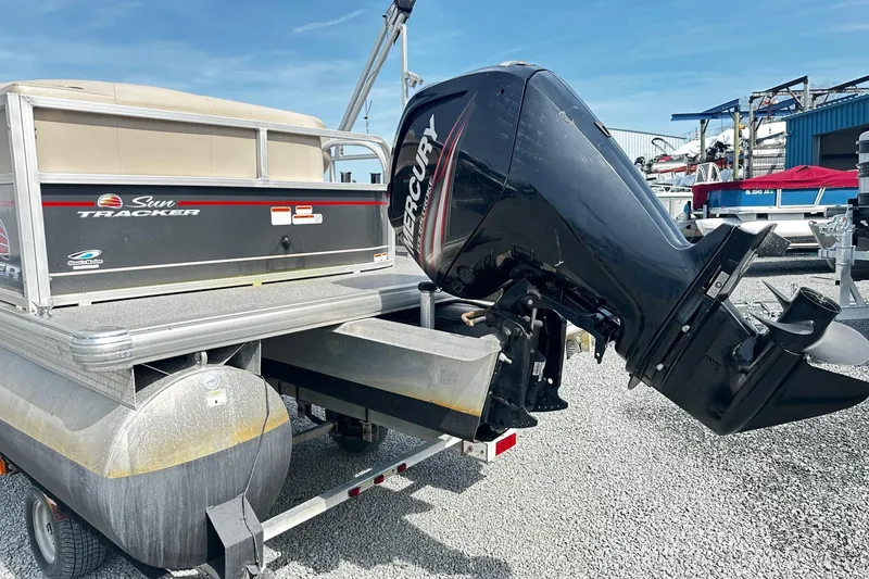 Slide: The Image of 2018 Sun Tracker Party Barge 18 DLX with Mercury outboard motor on gravel lot. - 21