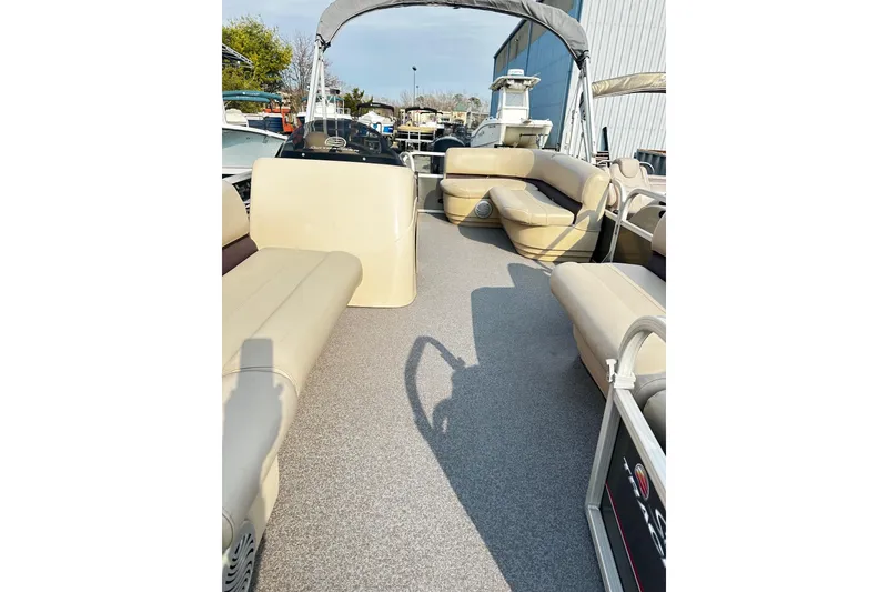 Slide: The Image of 2018 Sun Tracker Bass Buggy 18 Classic Series pontoon boat interior with beige seating. - 5