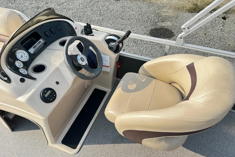 Slide: The Image of 2018 Sun Tracker Bass Buggy 18 Classic Series boat console with steering wheel and gauges. - 7