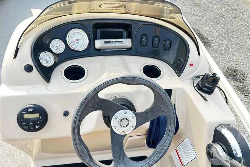 Slide: The Image of 2018 Sun Tracker Bass Buggy 18 Classic Series dashboard with steering wheel and gauges. - 8