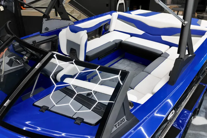 Slide: The Image of 2025 Axis T220 boat interior with blue and white seating, modern design. - 6