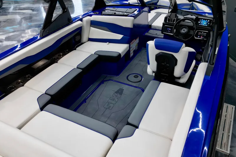 Slide: The Image of 2025 Axis T220 boat interior with blue and white seating, modern dashboard, and spacious layout. - 8