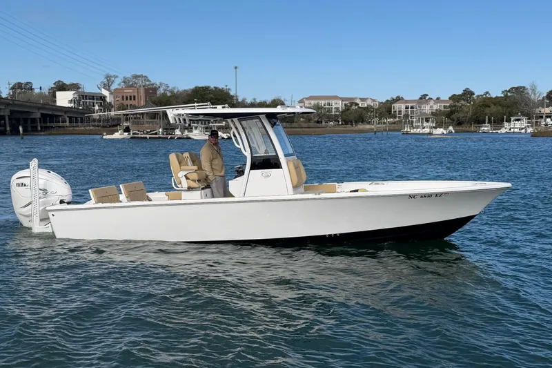 Slide: The Image of 2023 Sportsman Masters 267 Bay Boat cruising on a scenic waterway. - 12