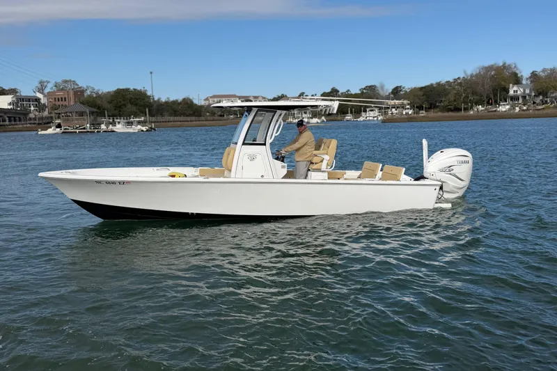 Slide: The Image of 2023 Sportsman Masters 267 Bay Boat cruising on a calm river. - 14