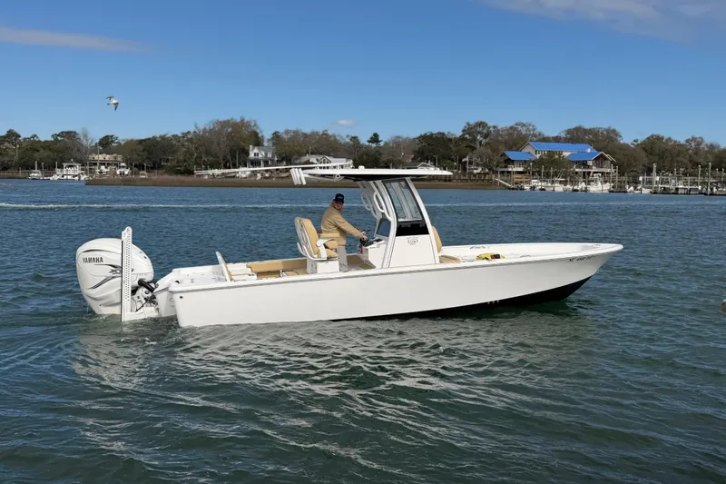 Slide: The Image of 2023 Sportsman Masters 267 Bay Boat cruising on a scenic waterway. - 17