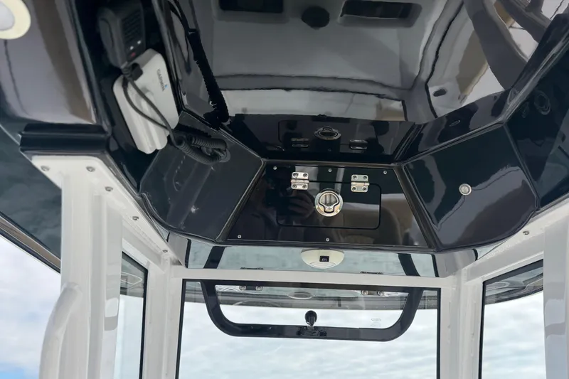 Slide: The Image of 2023 Sportsman Masters 267 Bay Boat console with electronics and storage compartments. - 23