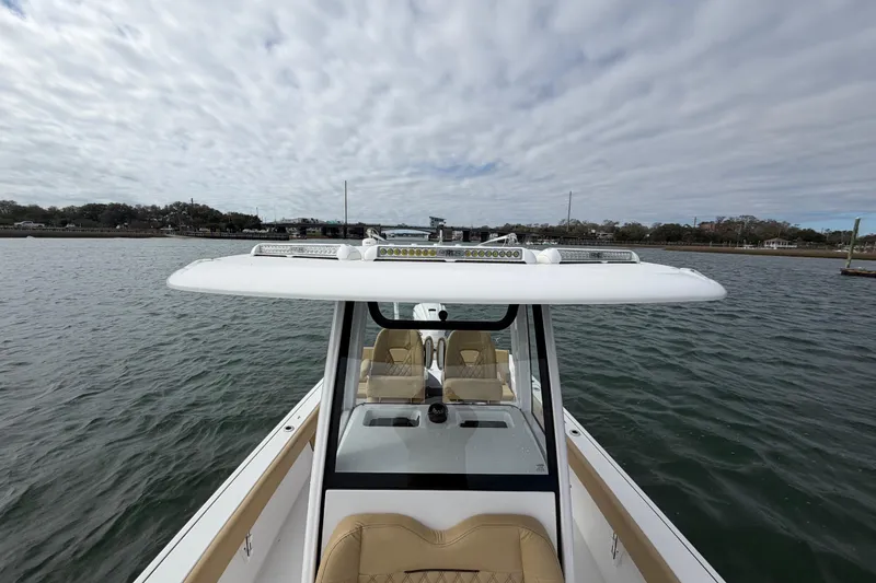 Slide: The Image of 2023 Sportsman Masters 267 Bay Boat on water under cloudy sky. - 25