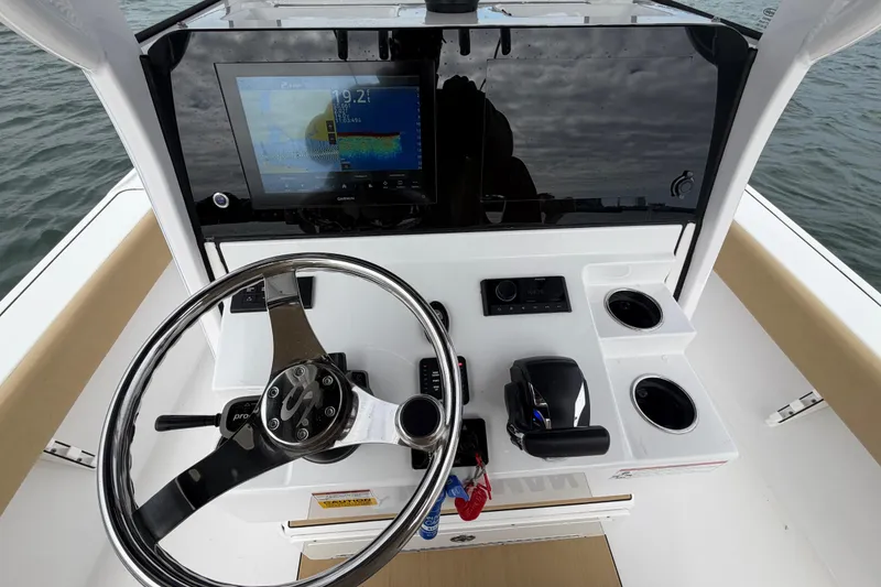 Slide: The Image of 2023 Sportsman Masters 267 Bay Boat helm with steering wheel and navigation display. - 28
