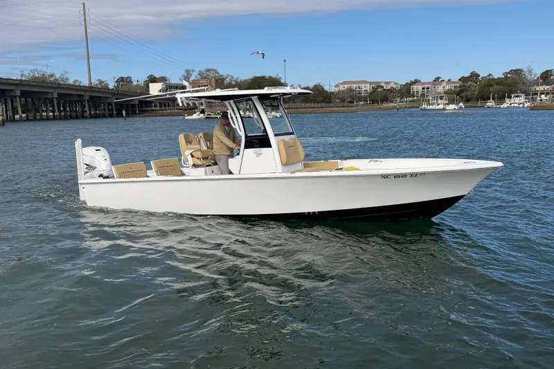 Slide: The Image of 2023 Sportsman Masters 267 Bay Boat cruising on a scenic waterway. - 3