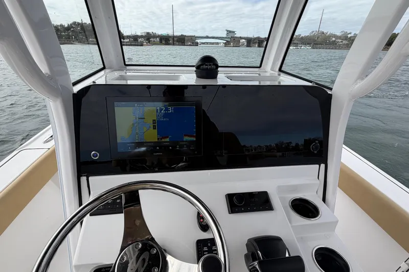 Slide: The Image of 2023 Sportsman Masters 267 Bay Boat dashboard with navigation display on water. - 30