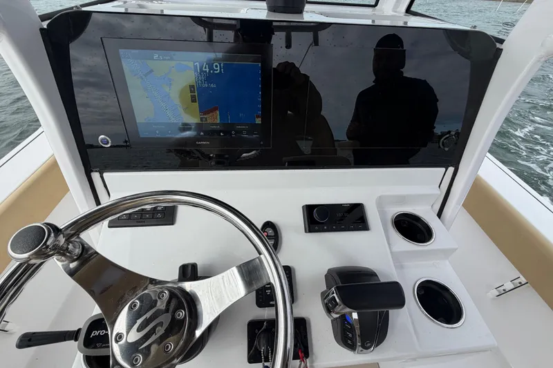 Slide: The Image of 2023 Sportsman Masters 267 Bay Boat dashboard with steering wheel and navigation display. - 39