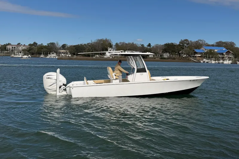 Slide: The Image of 2023 Sportsman Masters 267 Bay Boat cruising on a calm waterway. - 4
