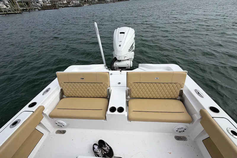 Slide: The Image of 2023 Sportsman Masters 267 Bay Boat with tan seating and powerful outboard motor. - 43