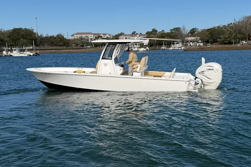 Slide: The Image of 2023 Sportsman Masters 267 Bay Boat cruising on a calm waterway. - 5