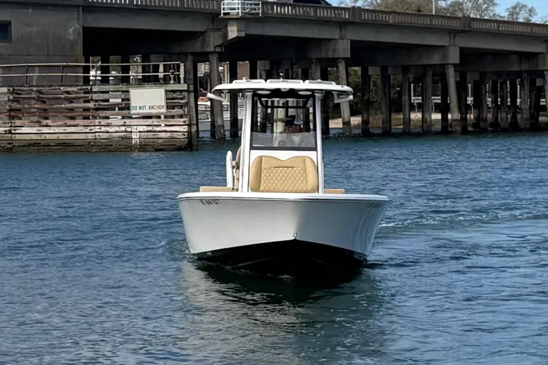 Slide: The Image of 2023 Sportsman Masters 267 Bay Boat cruising near a bridge on calm water. - 9