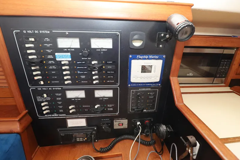 Slide: The Image of Electrical control panel on a 1996 Island Packet 40 yacht, featuring AC and DC systems. - 26