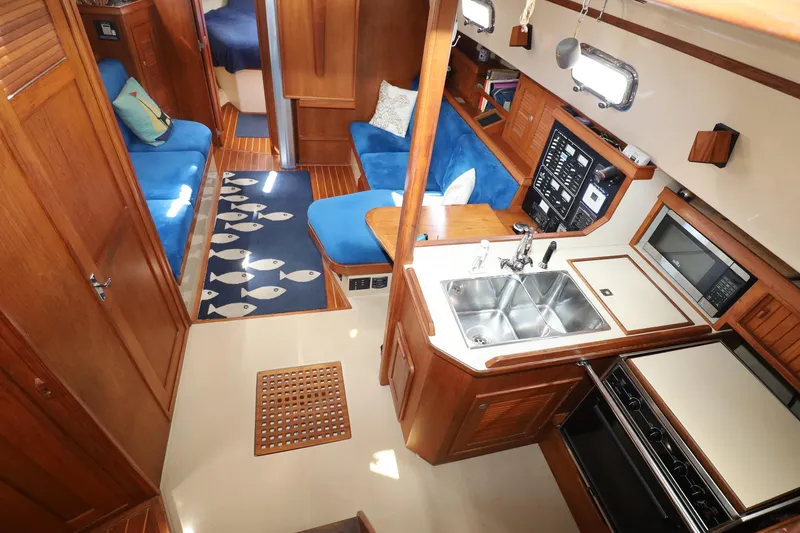 Slide: The Image of Interior of a 1996 Island Packet 40 sailboat with cozy seating and modern kitchen. - 3