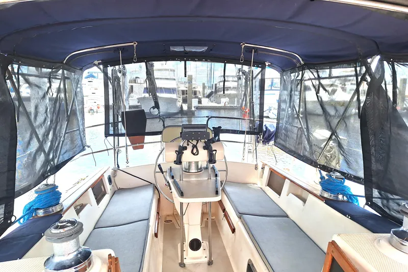 Slide: The Image of Interior view of a 1996 Island Packet 40 sailboat cockpit with seating and helm. - 37