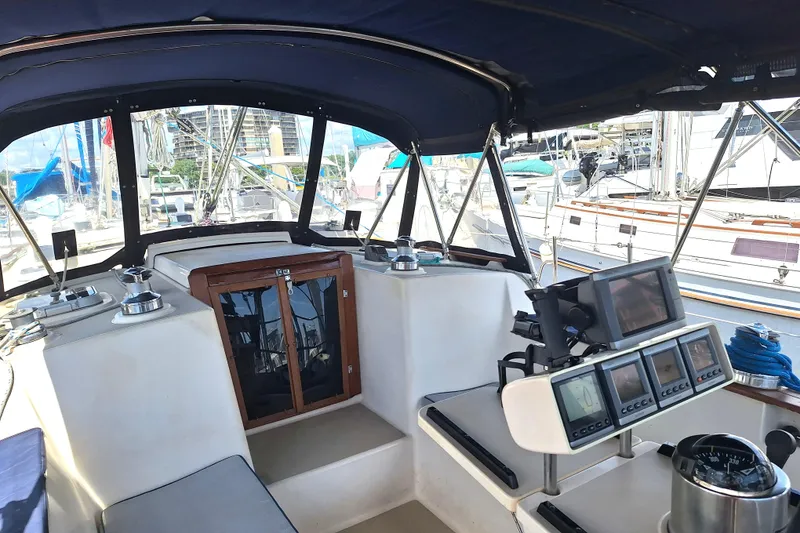 Slide: The Image of Interior view of a 1996 Island Packet 40 sailboat cockpit with navigation equipment. - 39