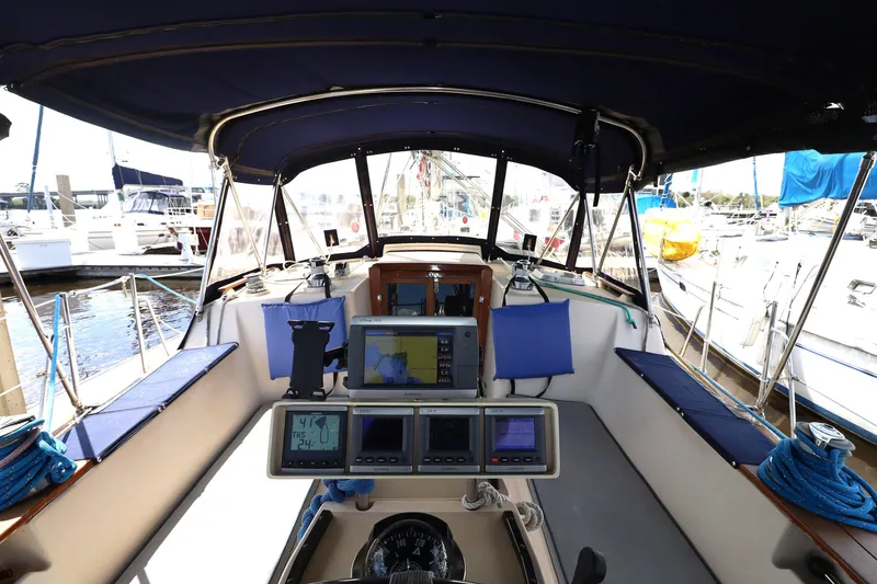 Slide: The Image of Cockpit view of a 1996 Island Packet 40 sailboat with navigation equipment and seating. - 40